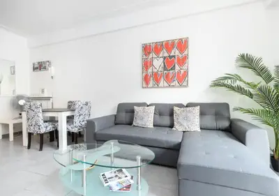 a living room with a couch and a table at Beautiful & spacious 2 bed Apt near Nice Center in Nice
