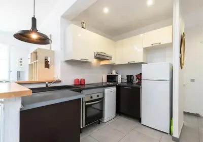 a balcony with a chair and some buildings at Beautiful & spacious 2 bed Apt near Nice Center in Nice