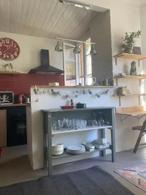 a kitchen with a counter with dishes on it at appartement cosy in Nice