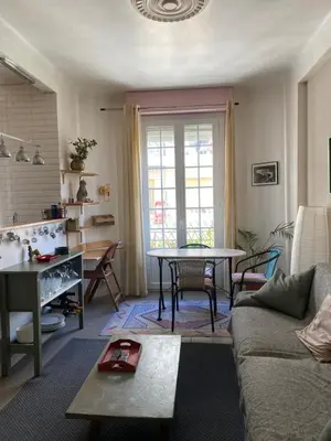 a living room with a couch and a table at appartement cosy in Nice