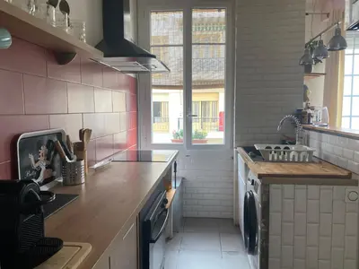 a kitchen with a sink and a stove top oven at appartement cosy in Nice