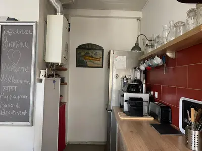 a kitchen with a refrigerator and a counter in a room at appartement cosy in Nice