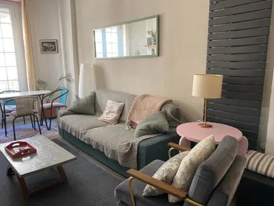 a living room with a couch and a table at appartement cosy in Nice