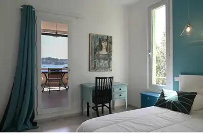 a bedroom with a bed and a desk and a table at Les Lucioles - Vue mer, AC, Wi-Fi, 4 pers in Villefranche-sur-Mer