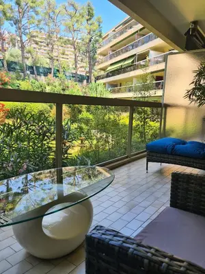 a balcony with a glass table and a large window at Studio grande terrasse à 5 min de la mer in Nice