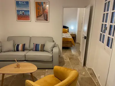 a living room with a couch and a table at Vieux-Nice 3 pièces confortable et calme in Nice