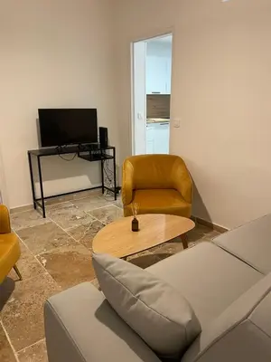 a living room with a couch and a table at Vieux-Nice 3 pièces confortable et calme in Nice