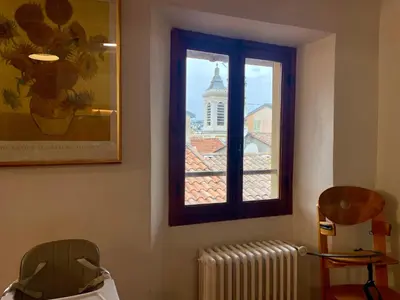 a window in a room with a radiator and a building at Triplex Toit-Terrasse Authentique Vieux-Nice & Mer in Nice