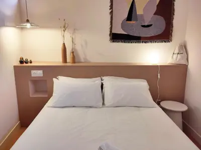 a bed with white pillows in a room at SLO Hostel Nice in Nice