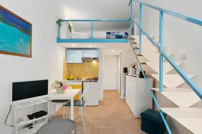 a small apartment with a staircase and a kitchen at Studio Azur FSH in Nice