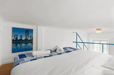 a white bedroom with a large bed with towels on it at Studio Azur FSH in Nice