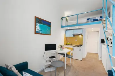 a small apartment with a desk and a bunk bed at Studio Azur FSH in Nice