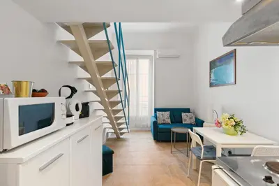 a living room with a kitchen and a living room with a table at Studio Azur FSH in Nice
