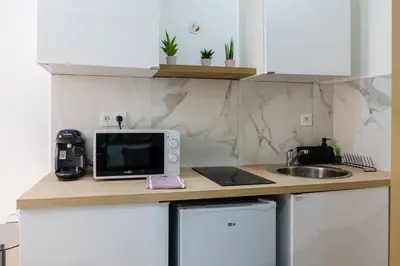 a kitchen with a counter with a microwave and a sink at Studio Nicehome Massena in Nice