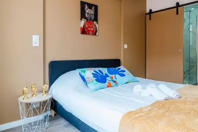 a bedroom with a bed and a side table at Studio Nicehome Massena in Nice