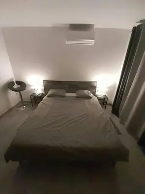 a bedroom with a bed with two pillows on it at Appartement spacieux &très calme. Spacious & very quiet apartment. in Carros
