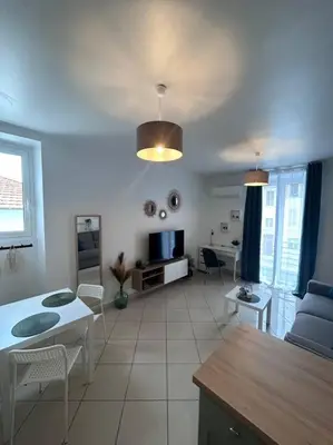 a living room with a couch and a table at Studio dans villa proche mer in Nice