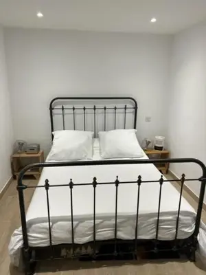 a black bed with white sheets and pillows in a room at Superbe appartement grande corniche vue sur mer Nice à 4 min du centre ville in Nice