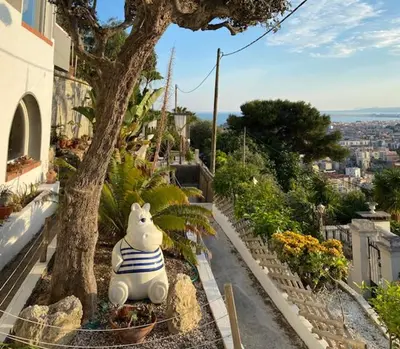 a stuffed animal sitting on the ground next to a tree at Superbe appartement grande corniche vue sur mer Nice à 4 min du centre ville in Nice