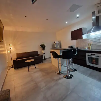 a kitchen and living room with a couch and a table at Vieille-Ville de Nice 2 pièces proche Mer in Nice