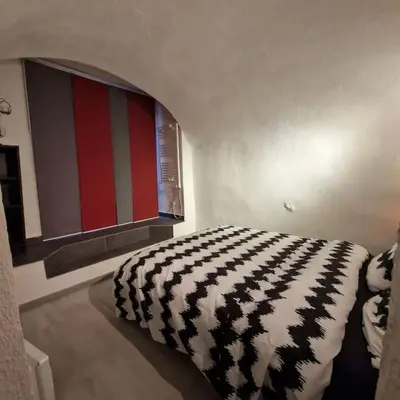 a bedroom with a black and white blanket on a bed at Vieille-Ville de Nice 2 pièces proche Mer in Nice