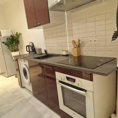 a kitchen with a stove and a sink and a dishwasher at Vieille-Ville de Nice 2 pièces proche Mer in Nice