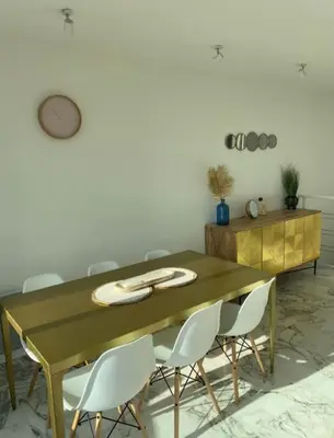 a dining room table with white chairs around it at Magnifique vue mer la Californie in Nice
