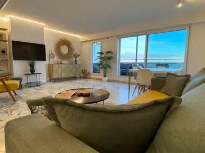 a living room with a couch and a table at Magnifique vue mer la Californie in Nice