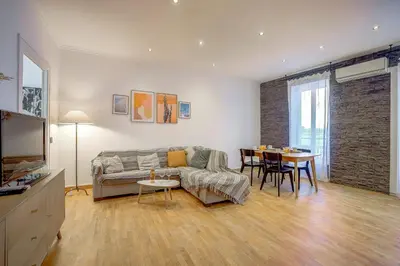 a living room with a couch and a table at Maison Bianchi - Chauvain Place Massena in Nice