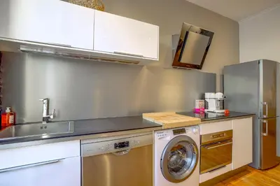 a kitchen with a sink and a washing machine at Maison Bianchi - Chauvain Place Massena in Nice