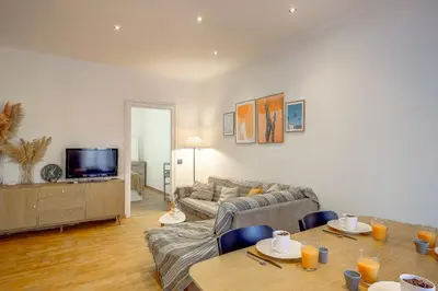 a living room with a couch and a table at Maison Bianchi - Chauvain Place Massena in Nice