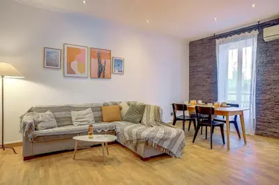 a living room with a couch and a table at Maison Bianchi - Chauvain Place Massena in Nice