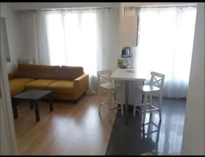 a living room with a couch and a table at En plein coeur de Nice in Nice