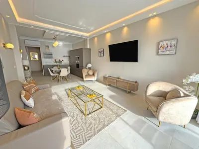 a living room with a couch and a flat screen tv at Sea Front Condo Promenade in Nice