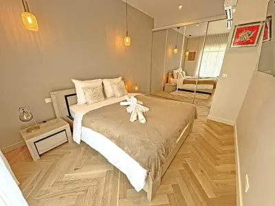 a bedroom with a bed with a white flower on it at Sea Front Condo Promenade in Nice
