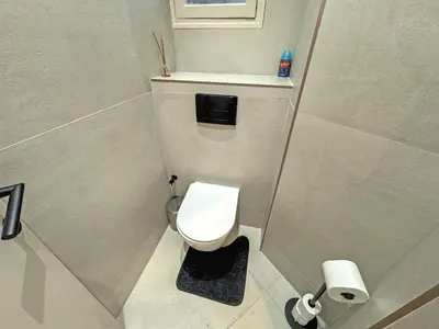a small bathroom with a toilet and a window at Sea Front Condo Promenade in Nice
