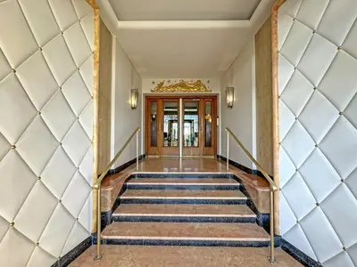 a hallway of a building with stairs and doors at Sea Front Condo Promenade in Nice