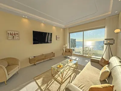 a living room filled with furniture and a large window at Sea Front Condo Promenade in Nice