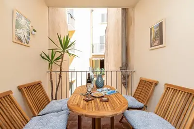 a wooden table with chairs in a room at MY CASA - MALONAT - Cosy Apart in Old Town w AC in Nice