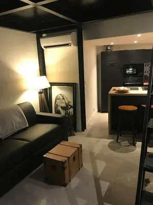 a living room with a couch and a table at Une atypique et merveilleuse Petite maison en plein cœur de Nice, à proximité de la mer et des plages in Nice