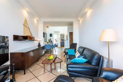 a living room with a couch and a table at LE FRANCE AP4350 By Riviera Holiday Homes in Nice