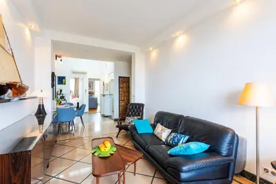 a living room with a leather couch and a table at LE FRANCE AP4350 By Riviera Holiday Homes in Nice