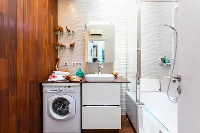 a bathroom with a washing machine and a sink at LE FRANCE AP4350 By Riviera Holiday Homes in Nice