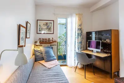 a living room with a couch and a desk with a computer at LE FRANCE AP4350 By Riviera Holiday Homes in Nice