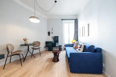 a living room with a blue couch and a table at Coeur de La Libé - Ideal couple & FRIENDS - CENTRAL & COSY - TRAM & Supermarkets -AC -Bed XXL in Nice