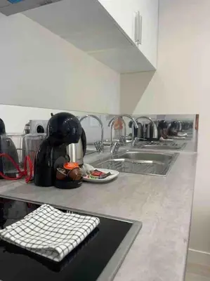 a kitchen with a sink and a counter with a keyboard at Le BASHKIR - SPACIEUX AVEC TERRASSE - WIFI - prés mer et aéroport - Tram et supermarchés in Nice