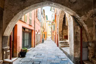 an alley in an old town with an archway at Le BASHKIR - SPACIEUX AVEC TERRASSE - WIFI - prés mer et aéroport - Tram et supermarchés in Nice