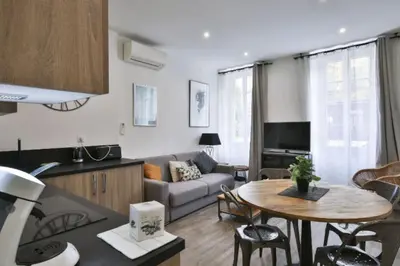 a kitchen and living room with a couch and a table at Appartement coeur du vieux Nice in Nice