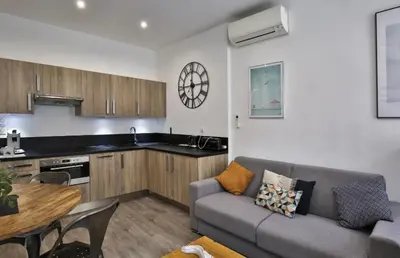 a living room with a table and a couch at Appartement coeur du vieux Nice in Nice