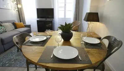 a living room with a couch and a kitchen at Appartement coeur du vieux Nice in Nice